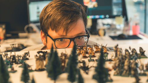 Man looking at miniature models