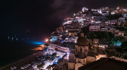 High angle view of illuminated buildings in city at night