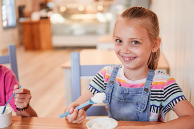 Portrait of smiling girl holding indoors