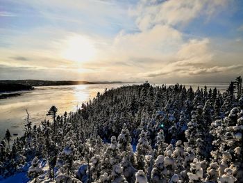 Panoramic view of frozen lake against sky during sunset