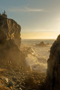 Scenic view of sea and mountains against sky