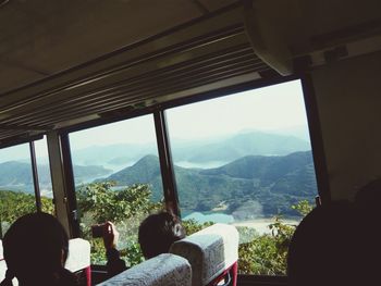 Rear view of man looking through window