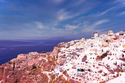 High angle view of townscape by sea against sky