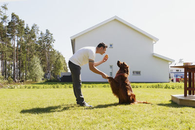 Man shaking dog paw