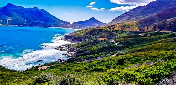 Scenic view of sea and mountains against sky