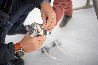 Low section of man repairing car