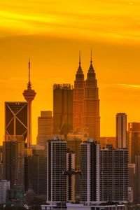 Modern buildings in city during sunset