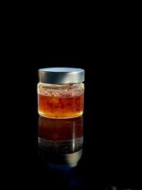 Close-up of beer glass against black background