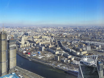 High angle view of buildings against blue sky