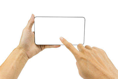 Low section of person holding smart phone against white background