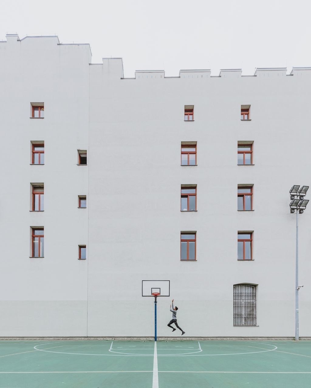 MAN WITH UMBRELLA ON BUILDING