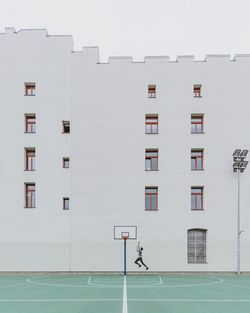 Man walking in front of building