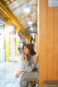 Full length of woman standing in corridor