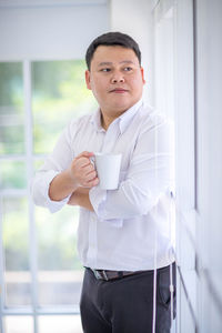 Portrait of a young man drinking coffee