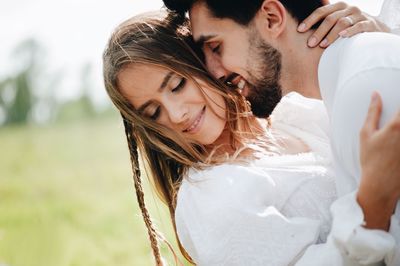 Close-up of young couple romancing outdoors