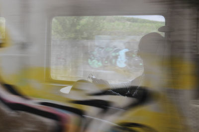 Reflection of man on train window