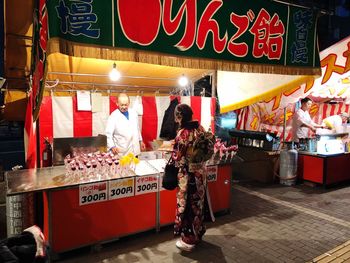 People at market stall in city