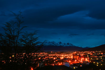 Illuminated cityscape against sky at night