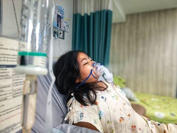 A girl is receiving medicine through her nose.  asthma patients