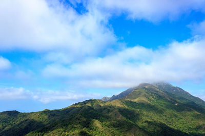 Low angle view of mountain against cloudy sky