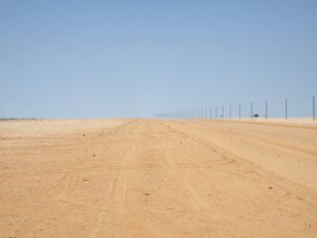 Barren landscape against clear blue sky