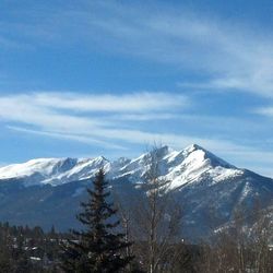 Scenic view of snow covered mountains against sky