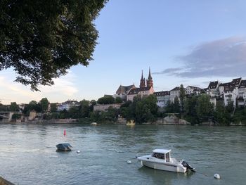 Boats in river against buildings