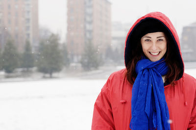 Beautiful woman standing in snow during winter outdoors