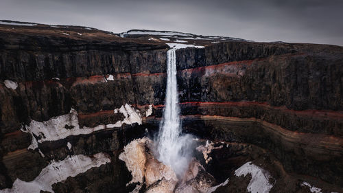 Moody aerial drone view of volcanic hengifoss waterfall, northern iceland