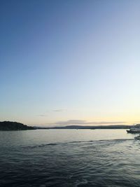 Scenic view of sea against clear sky during sunset