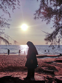 People on beach at sunset