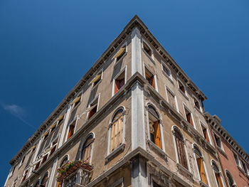 Low angle view of building against clear blue sky