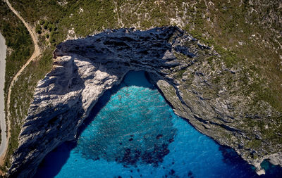 Aerial view of winding road by sea