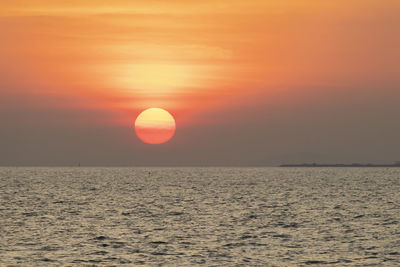 Scenic view of sea against orange sky