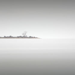 Scenic view of sea against clear sky during winter