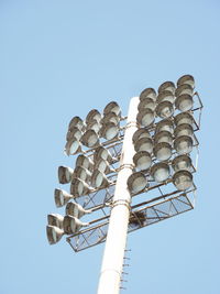 Low angle view of floodlight against clear blue sky