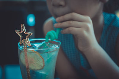Midsection of man drinking glass