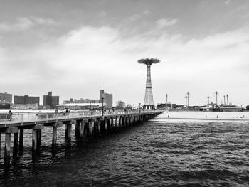 View of pier over sea against cloudy sky