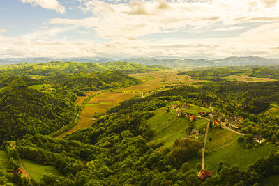 Aerial panorama of of green hills and vineyards with mountains. austria vineyards landscape.