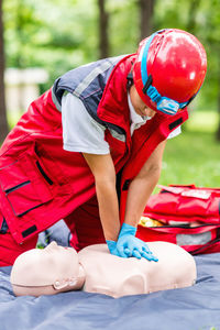 Healthcare worker practicing on cpr dummy at park