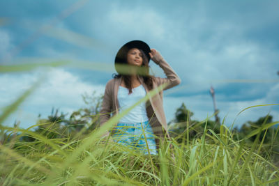 Woman standing on grassy field