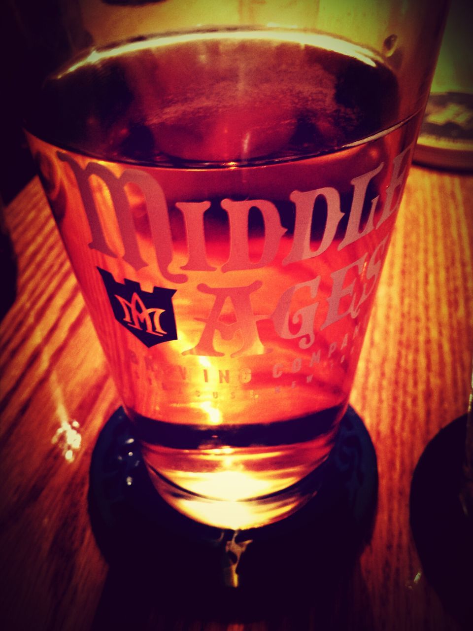 drink, text, food and drink, close-up, refreshment, western script, indoors, glass - material, drinking glass, still life, alcohol, table, communication, freshness, transparent, red, no people, focus on foreground, beer glass, beer - alcohol