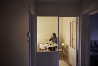 Man eating dinner alone at home