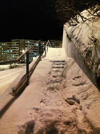 Illuminated walkway at night