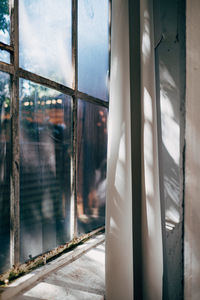 Reflection of sky seen through glass window of building