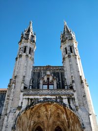 Low angle view of bell tower against sky