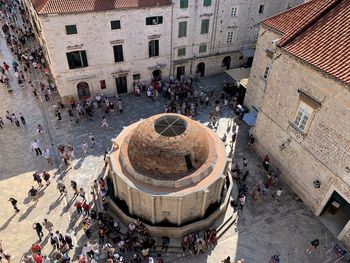 High angle view of people on street amidst buildings in town