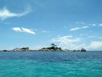 Scenic view of sea against blue sky