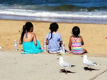 Rear view of people on beach