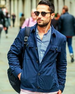 Young man wearing sunglasses standing outdoors